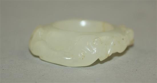 A Chinese white jade archers thumb ring, 18th / 19th century, 3cm